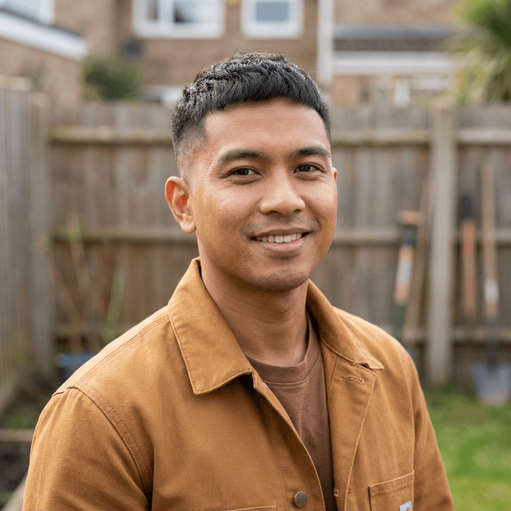 Robert Chen, son of a senior care client, in his early 50s, in a comfortable living room
